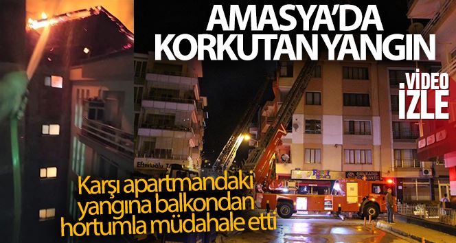 Karşı apartmandaki yangına balkondan hortumla müdahale etti